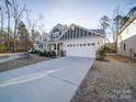 Spacious driveway leading to the home's two-car garage, with beautiful landscaping surrounding it at 5028 Colline Ct, Charlotte, NC 28216