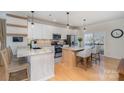 Modern kitchen features white cabinets, stainless steel appliances, and granite countertops at 6503 Revolutionary Trl, Charlotte, NC 28217