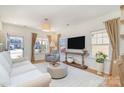 Bright living room with hardwood floors, a large window, and neutral decor at 6503 Revolutionary Trl, Charlotte, NC 28217
