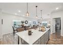 Bright, open-concept kitchen featuring a large island, modern pendant lighting, and stainless steel appliances at 6509 Gopher Rd, Lancaster, SC 29720