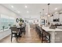Spacious open floor plan showcases the kitchen with breakfast bar and dining area with wood flooring at 6509 Gopher Rd, Lancaster, SC 29720