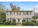 Charming two-story home featuring a symmetrical facade, manicured bushes and classic black shutters at 775 Summerwood Dr, Rock Hill, SC 29732