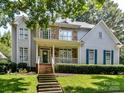 Inviting two-story home with stone accents and a covered front porch at 9409 Gilpatrick Ln, Huntersville, NC 28078