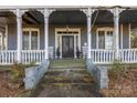 Inviting front porch with classic columns and a cozy seating area, perfect for relaxing outdoors at 121 York St, Chester, SC 29706