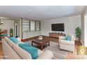 Staged living room featuring hardwood floors, a built-in bookcase, and neutral tones at 1323 Queens Rd # 308, Charlotte, NC 28207