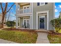 Inviting front porch features seating, a blue front door with wreath, and manicured landscaping for great curb appeal at 14462 Holly Springs Dr, Huntersville, NC 28078