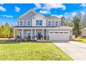 Lovely two-story home with a spacious driveway, a two-car garage and a welcoming porch at 146 Allenton Way, Statesville, NC 28677