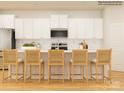 Bright kitchen with white cabinets, stainless steel appliances, and counter seating at 1566 Croydon St, Indian Land, SC 29707