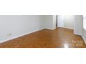 Bright bedroom featuring hardwood floors, neutral walls, and an ensuite bathroom entrance at 1825 Hyatt Ave, Rock Hill, SC 29732