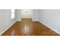 Spacious living room featuring hardwood floors, neutral walls, and ample natural light at 1825 Hyatt Ave, Rock Hill, SC 29732