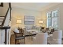 Bright living room featuring shuttered windows, comfortable seating, and neutral decor at 2010 Nolen Park Ln, Charlotte, NC 28209