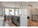 The kitchen has stainless steel appliances, an island with barstools, and is open to the adjacent dining area at 2014 Bryant Park Dr, Charlotte, NC 28208