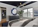 Cozy bedroom featuring a large window, ceiling fan, and stylish decor at 2338 Yadkin Ave # 205, Charlotte, NC 28205