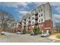 Modern condo building with brick and steel, featuring private balconies and ample parking at 2338 Yadkin Ave # 205, Charlotte, NC 28205
