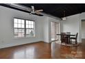 Bright living space with stained concrete floors, ceiling fan, and large windows at 2338 Yadkin Ave # 205, Charlotte, NC 28205