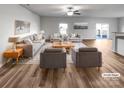 Bright living room featuring hardwood floors, neutral decor, and a comfortable seating arrangement at 2451 Rhyne Rd, Dallas, NC 28034