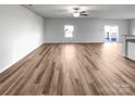 Bright living room featuring hardwood floors, neutral decor, and a sliding glass door at 2451 Rhyne Rd, Dallas, NC 28034