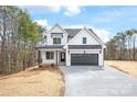 New construction home with white siding, black trim and a spacious driveway at 3646 46Th Ne Ave, Hickory, NC 28601
