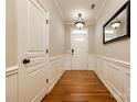 Bright entryway featuring hardwood floors, wainscoting, and a stylish mirror at 510 Pine Links Dr, Tega Cay, SC 29708