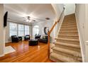 Open living room with hardwood floors, staircase, and an abundance of natural light at 510 Pine Links Dr, Tega Cay, SC 29708