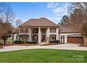 Beautiful two-story home with a well-manicured lawn, traditional architecture, and an attached two-car garage at 706 Eagle Point Ct, Weddington, NC 28104