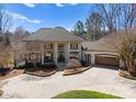 Stately home featuring a circular driveway and a grand facade with columns and attached two-car garage at 706 Eagle Point Ct, Weddington, NC 28104