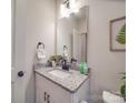 Cozy half bathroom boasts a granite countertop vanity and modern fixtures at 711 E 3Rd Ave, Gastonia, NC 28054