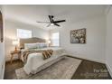 Calm bedroom featuring a ceiling fan, plush bed, and hardwood floors at 119 N Smallwood Pl, Charlotte, NC 28216