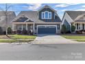 Inviting two-story home featuring a well-maintained lawn and a spacious driveway at 1284 Independence St, Tega Cay, SC 29708