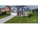 Charming two-story home with brick and siding, attached two-car garage and well-maintained lawn at 137 Tenth Green Ct, Statesville, NC 28677