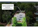 Beautiful two-story blue home with a spacious front yard and clearly marked boundary lines at 208 Cape August Pl, Belmont, NC 28012