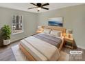 Cozy bedroom with a queen-sized bed, soft rug, and a large window bringing in natural light at 215 Creek View Rd, Mooresville, NC 28117