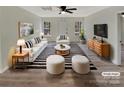 Bright living room featuring modern furniture, a striped rug, and plenty of natural light from the windows at 215 Creek View Rd, Mooresville, NC 28117