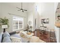 Bright living room featuring vaulted ceiling, large window, modern decor, and hardwood flooring at 301 E Tremont Ave # 314, Charlotte, NC 28203