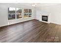 Spacious, naturally lit living room featuring a fireplace and beautiful hardwood floors at 3161 Glen Robin Ct, Charlotte, NC 28205