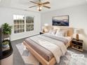 Inviting main bedroom features a tray ceiling, ceiling fan, and a large bright window at 3161 Glen Robin Ct, Charlotte, NC 28205