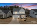Stunning two-story home with a two-car garage, covered porch, and manicured lawn at 4159 Millstream Rd, Denver, NC 28037