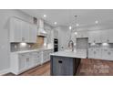 A great view of kitchen featuring hardwood floors, stone counters, stainless appliances and pendant lights at 6055 Brush Crk, Monroe, NC 28110
