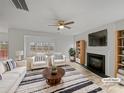 Bright living room with fireplace, hardwood floors, and a large window showcasing natural light at 609 Sunset Point Dr, Rock Hill, SC 29732