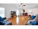 Inviting living room with wood floors, entertainment center, and a view into the kitchen at 662 Georgie St, Troutman, NC 28166