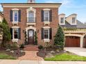 Beautiful brick home with elegant detailing, landscaped yard, and inviting entrance at 6711 Conservatory Ln, Charlotte, NC 28210