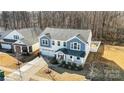 Aerial view of a charming two-story home with a well-manicured lawn and driveway at 7535 Meridale Forest Dr # 107, Charlotte, NC 28269