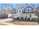 Inviting two-story home with a covered front porch and well-maintained lawn at 7535 Meridale Forest Dr # 107, Charlotte, NC 28269