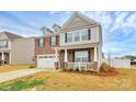 Beautiful two-story house with brick and siding, a cozy front porch, and a two-car garage at 9203 Mackinaw Dr, Gastonia, NC 28056