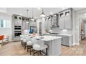 Spacious kitchen with sleek gray cabinets, quartz countertops, and a large island with bar seating at 1039 Rabbit Hill Ln, Monroe, NC 28110