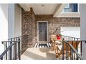 Charming front porch featuring a bistro set, brick siding and a welcoming 'hello' doormat at 1051 Lookout Shoals Dr, Fort Mill, SC 29715