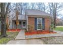 Cozy home has blue shutters, neatly manicured flowerbeds and a concrete walkway at 11127 Sevilla Ct, Charlotte, NC 28226