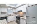 Bright kitchen featuring white cabinets, granite countertops, and modern appliances at 11127 Sevilla Ct, Charlotte, NC 28226