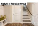 Hallway featuring an entryway bench with storage and a staircase to the upper level at 113 Noah Ln, Troutman, NC 28166