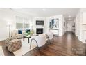 Inviting living room with a fireplace, modern decor, and hardwood flooring at 115 Noah Ln, Troutman, NC 28166